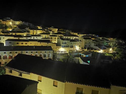 a view of a city at night with buildings at La Casa de los Pájaros in Vélez Blanco
