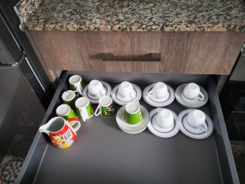 a tray with plates and cups on a table at La Casa de los Pájaros in Vélez Blanco