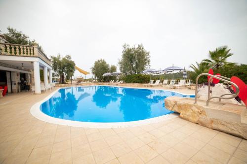 a swimming pool in a resort with a slide at Residence Il Falco in Vieste