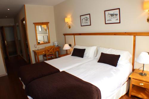 Een bed of bedden in een kamer bij Hotel Meta