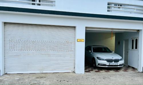 a car is parked inside of a garage at M town Homestay in Kodaikānāl