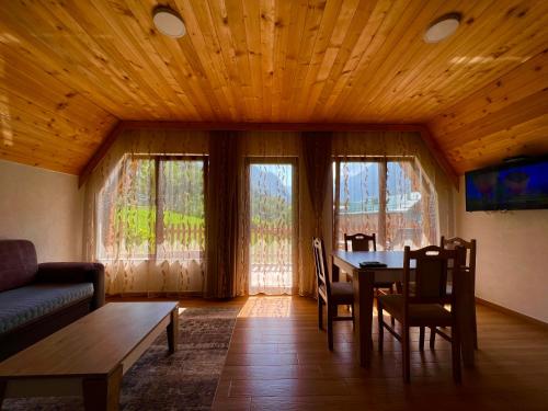 a living room with a table and a couch at Villa Dardania in Peje