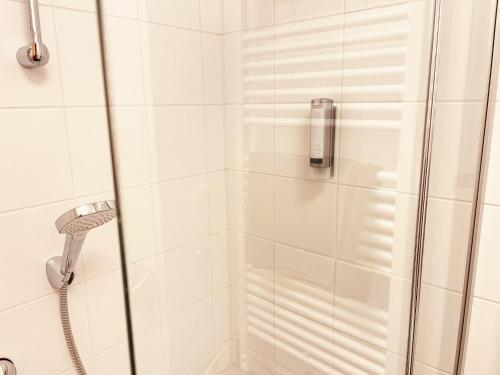 a shower with a glass door in a bathroom at Modern Mountain Apart directly by Skiing area in Rauris