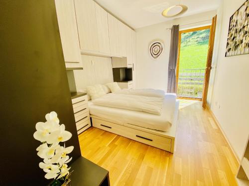 a bedroom with a bed and a large window at Modern Mountain Apart directly by Skiing area in Rauris