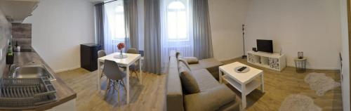 a living room with a couch and a tv at Sky Thermal Apartment in Karlovy Vary