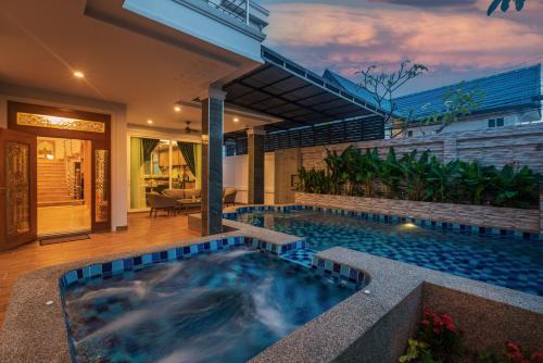 a swimming pool in the middle of a house at Grand Gala Villa in Pattaya South