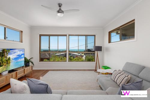 a living room with a couch and a tv at Picturesque Portarlington in Portarlington