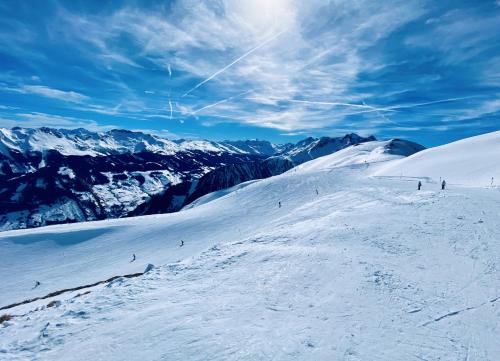 a group of people skiing down a snow covered mountain at Modern Mountain Apart 2 - directly by Skiing area in Rauris