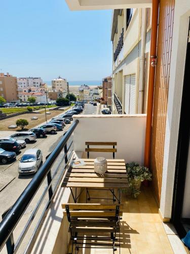 a balcony with a table and chairs and a street at Azul sea’s view flat (3bedrooms), 3 terraces/wifi in Buarcos
