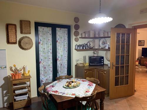 a kitchen with a table with a plate of food on it at Villa Franca in Castelluccio Inferiore