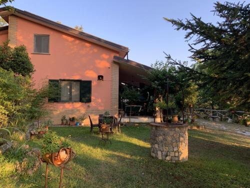 a house with a yard with a table and chairs at Villa Franca in Castelluccio Inferiore