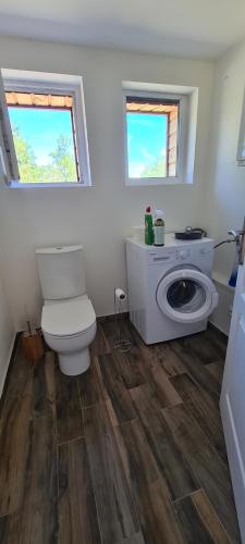 a bathroom with a toilet and a washing machine at La- ch'tite-Gamassette in Carlucet