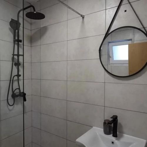 a bathroom with a mirror and a sink at Vila Nomada in Blagaj
