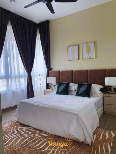 a bedroom with a large bed with a ceiling fan at d'Bunga Troika Kota Bharu #Wifi #Netflix in Kota Bharu