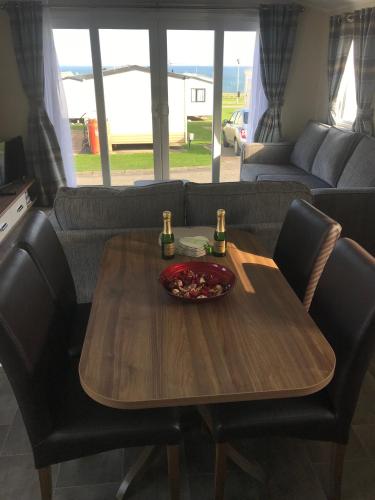 a wooden table with a bowl of food on top at Crimdon dene holiday park in Hartlepool