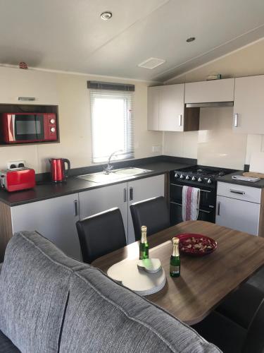 a kitchen with a table with two bottles on it at Crimdon dene holiday park in Hartlepool