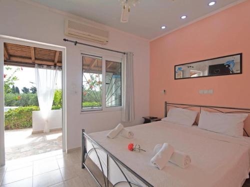 a bedroom with a bed with towels on it at Alluring apartment in Mpenitses with shared pool in Benitses