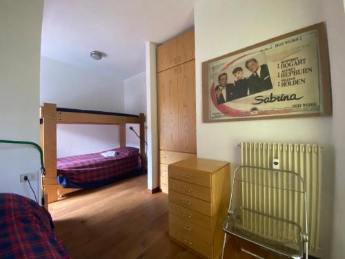 a bedroom with a bunk bed and a poster on the wall at Enjoy Sauze d'Oulx in Sauze dʼOulx