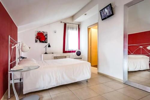 a bedroom with a white bed and a glass table at Cà Dei Barcaroli in Mestre
