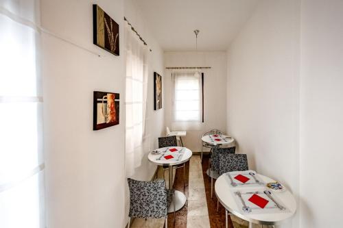 two tables and chairs in a room with white walls at Cà Dei Barcaroli in Mestre