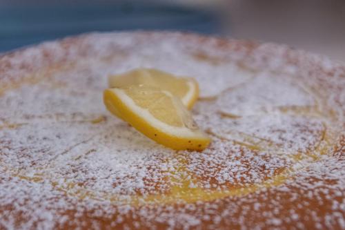 a piece of lemon sitting on top of a cake at B&B Airone Cervia - Camere e Appartamenti in Cervia