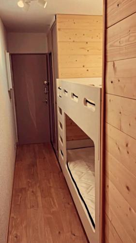 a tiny house with a bed in a room at LeChalet N22 Au pied des pistes in Saint-Lary-Soulan