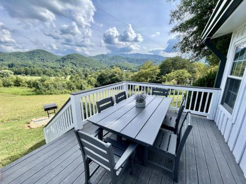 una terraza de madera con mesa y sillas. en Peace of Paradise home, en Townsend