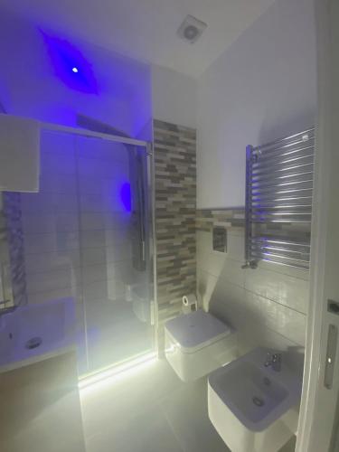 a bathroom with a shower and a toilet and a sink at Mamuccia Rooms Posto Auto in Naples