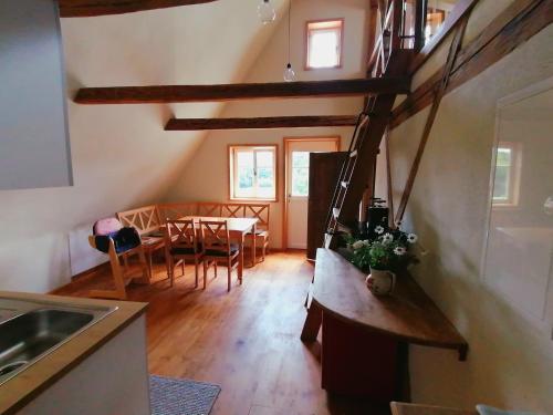 a kitchen and dining room with a table and chairs at Pferdehof am Burgsberg, Ferienwohnungen in Seifhennersdorf