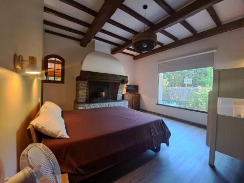 a bedroom with a large bed and a fireplace at Gîte l'Interlude in Mons