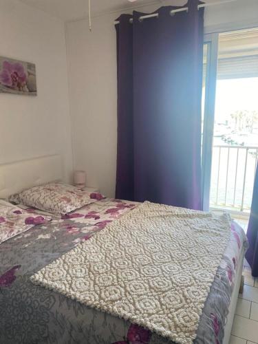 une chambre avec un lit et une fenêtre dans l'établissement Magnifique Appart Marina proche plage avec parking, à Sète