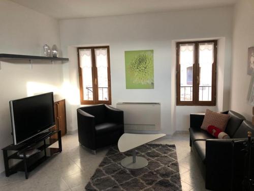 a living room with a couch and a flat screen tv at Casa Ornella in Nocera Umbra