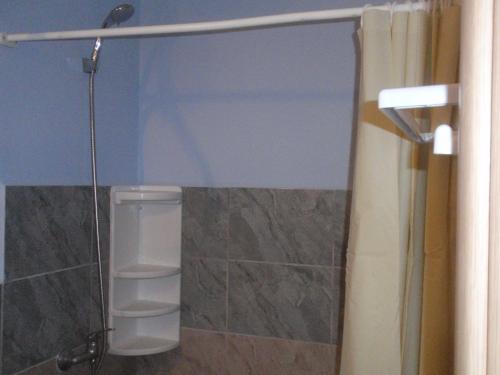 a bathroom with a shower with a glass separator at Traditional Studio in Kalymnos