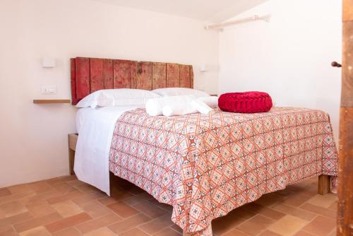 a bedroom with a bed with a red blanket at Dilà Assisi Rooms in Assisi