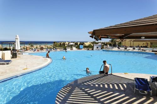 a group of people in a swimming pool at Three Corners Fayrouz Plaza Beach Resort in Port Ghalib