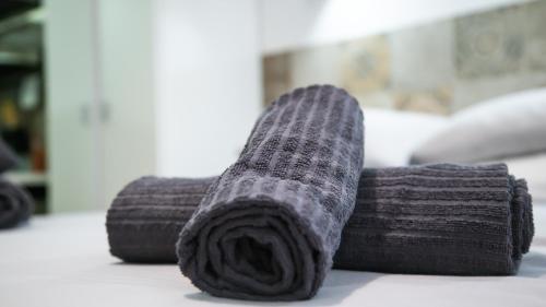a close up of a roll of dark gray towels at Hotel Apartamentos Pueblo Mar in Calpe