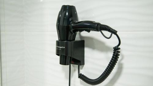 a black phone is hanging on a wall at Hotel Apartamentos Pueblo Mar in Calpe