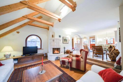 a living room with a couch and a fireplace at Villa Dona in Kranjska Gora