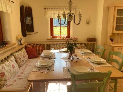 a dining room with a table with plates and glasses at Villa Dona in Kranjska Gora