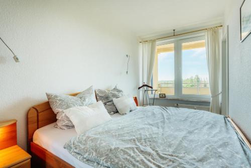1 dormitorio con 1 cama grande y ventana en Ferienwohnung Harz-Panorama 434 en Hohegeiß