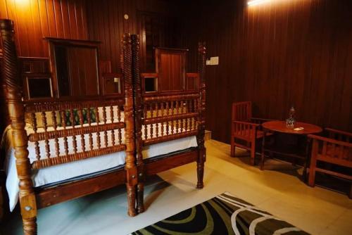a room with a wooden bench and a table at Fort Bridge View in Cochin