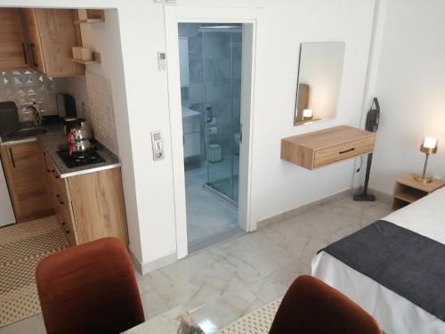 a bedroom with a bathroom with a glass shower at Bo homes suıt apart in Demre