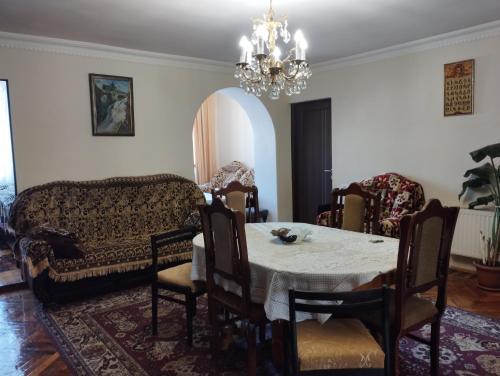 a living room with a table and a couch at Tsovella House in Jermuk