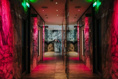 a hallway with red and green lights on the walls at The Ciao Stelio Deluxe Boutique Hotel - Adults Only in Larnaka
