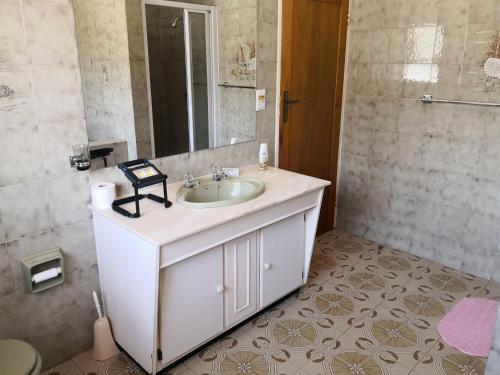 a bathroom with a sink and a mirror at CHIC Guest House & Solar system accommodations in Germiston
