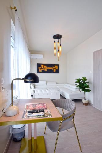 a living room with a table and a couch at John's Hotel in Chalkida