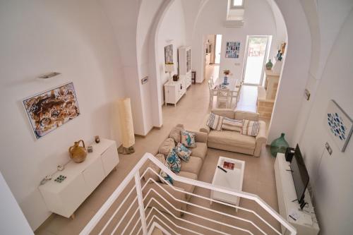 an overhead view of a living room with a staircase at Casa Margherita - typical salento house in Castrignano del Capo