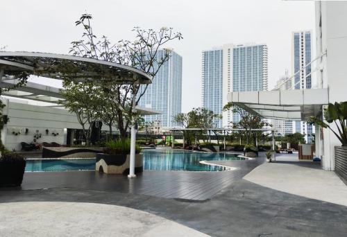 a pool in the middle of a city with tall buildings at U Residence Tower2 Supermal by Lippo Karawaci in Klapadua