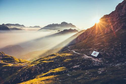 a view of a mountain with the sun in the background at Residence Soča in Soča