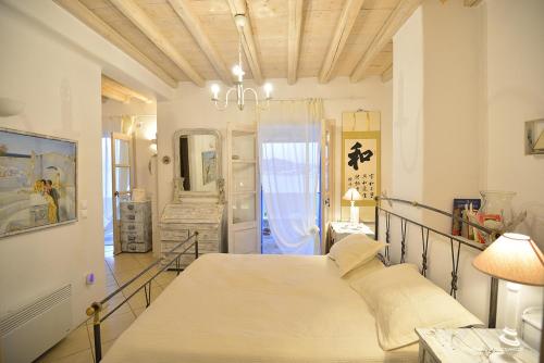 a bedroom with a large bed in a room at Aegean Pearl in Ornos